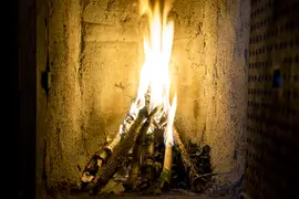 First fire burning in the repaired fireplace