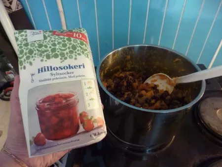Adding sugar to the jam Adding sugar to the jam